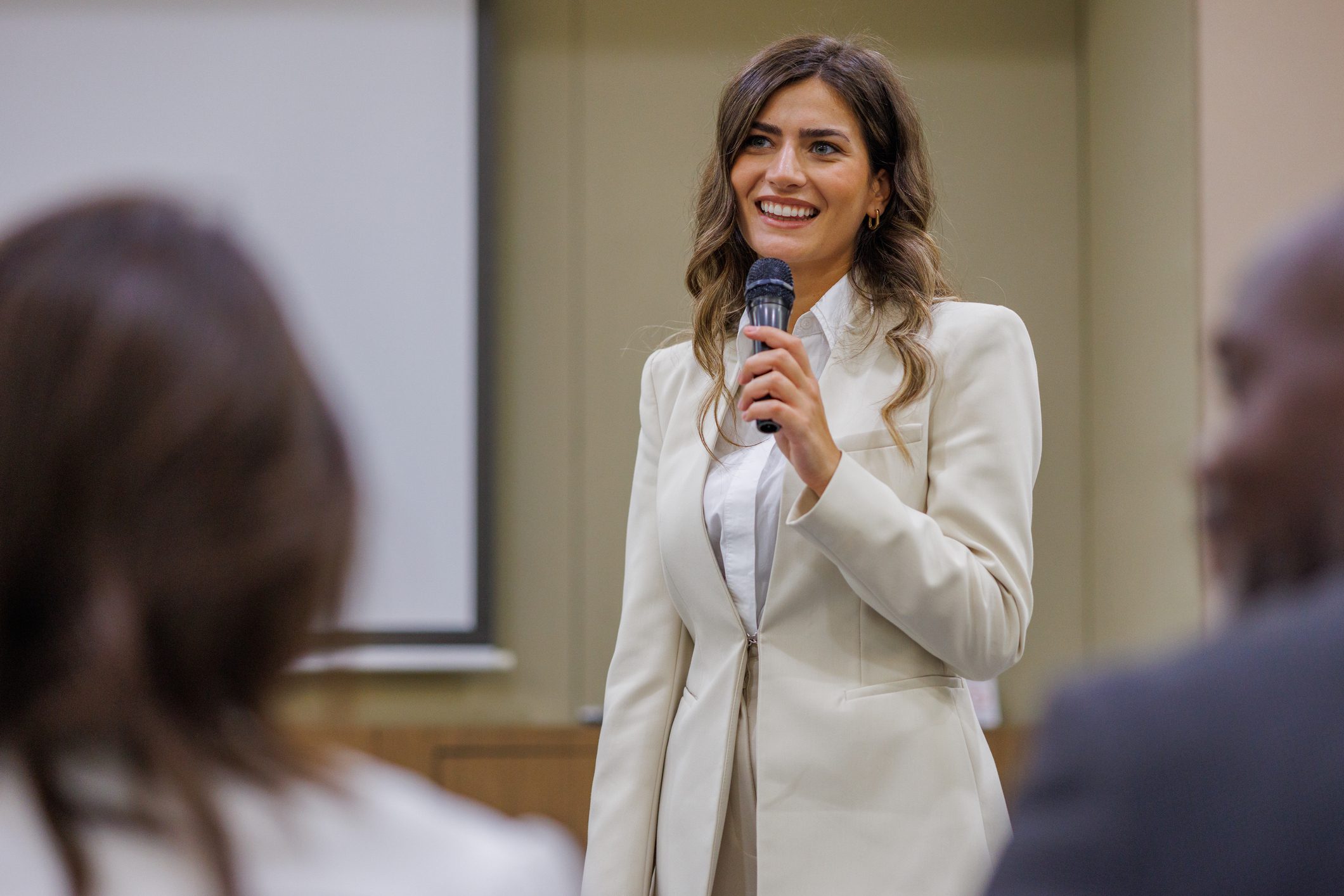 Confident speaker addressing audience in meeting